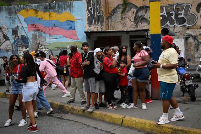 People remain in the street following an earthquake in Caracas on June 24, 2026. A magnitude 7.1 earthquake struck Venezuela on Wednesday, the United States Geological Survey (USGS) reported, triggering panic in Caracas, according to AFP journalists. The tremor, which was followed by several aftershocks, was also felt in Colombia. (Photo by Federico PARRA / AFP)
