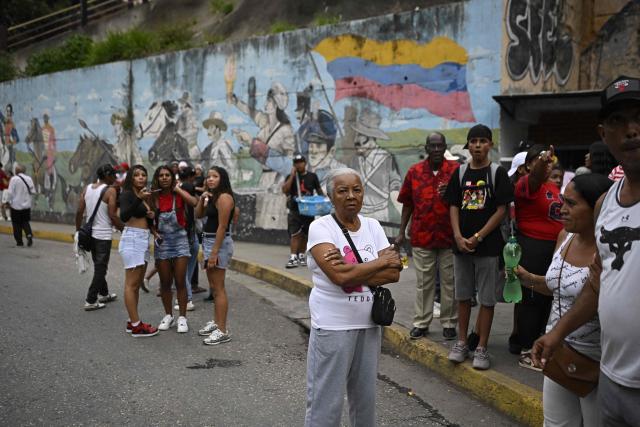 People remain in the street following an earthquake in Caracas on June 24, 2026. A magnitude 7.1 earthquake struck Venezuela on Wednesday, the United States Geological Survey (USGS) reported, triggering panic in Caracas, according to AFP journalists. The tremor, which was followed by several aftershocks, was also felt in Colombia. (Photo by Federico PARRA / AFP)