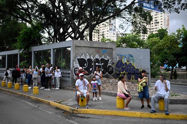 People remain in the street following an earthquake in Caracas on June 24, 2026. A magnitude 7.1 earthquake struck Venezuela on Wednesday, the United States Geological Survey (USGS) reported, triggering panic in Caracas, according to AFP journalists. The tremor, which was followed by several aftershocks, was also felt in Colombia. (Photo by Federico PARRA / AFP)