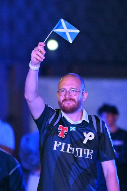 A Scotland supporter waves his flag while watching the 2026 World Cup Group C football match between Scoland and Brazil, at the 4TheFans Fan Park at The Pitt in Edinburgh, Scotland early on June 25, 2026. (Photo by ANDY BUCHANAN / AFP)
