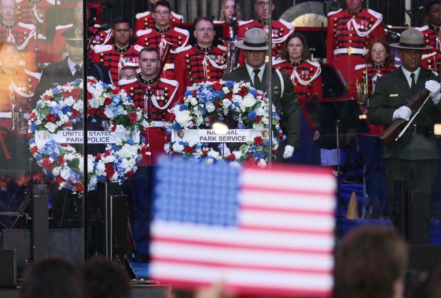 Wreaths are displayed on stage during a commemorative tribute to military personnel and law enforcement officers who died in the line of duty, during a kick-off celebration for the "Great American State Fair" on the National Mall in Washington, DC, June 24, 2026. The "Great American State Fair" will be held from June 25 to July 10, 2026, to celebrate the 250th anniversary of US independence. (Photo by Jemal COUNTESS / AFP)