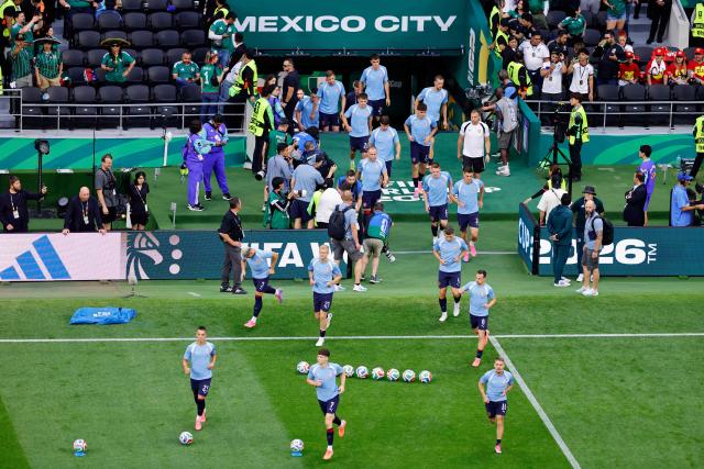 Czech Republic's players walk onto the pitch to warm up ahead of the 2026 World Cup Group A football match between the Czech Republic and Mexico at the Mexico City Stadium in Mexico City on June 24, 2026.  (Photo by Rodrigo Oropeza / AFP)