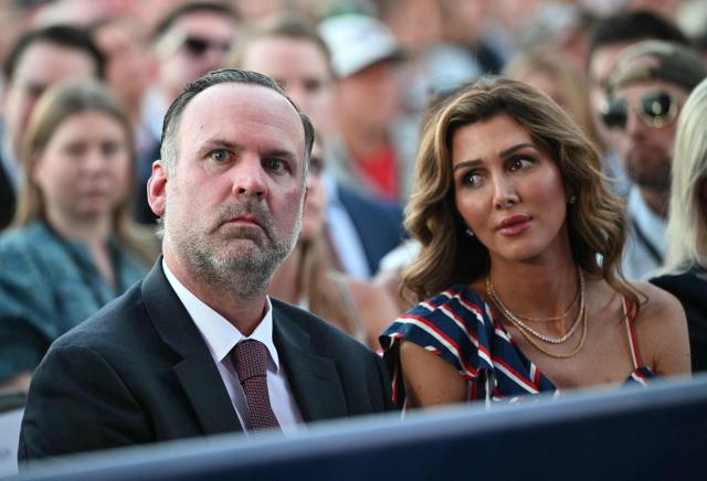 White House Deputy Chief of Staff Dan Scavino and his wife  Erin Elmore listen to a speaker during a kick-off celebration for the "Great American State Fair" on the National Mall in Washington, DC, June 24, 2026. The "Great American State Fair" will be held from June 25 to July 10, 2026, to celebrate the 250th anniversary of US independence. (Photo by Mandel NGAN / AFP)