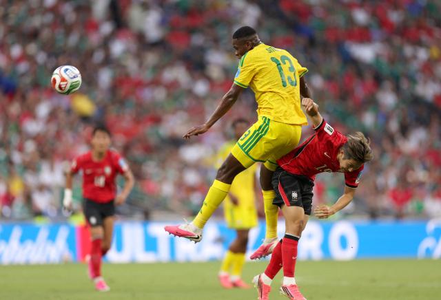 South Africa's midfielder #13 Sphephelo Sithole and South Korea's midfielder #19 Lee Kang-in fight for the ball during the 2026 World Cup Group A football match between South Africa and South Korea at the Monterrey Stadium in Guadalupe, Mexico, on June 24, 2026.  (Photo by Julio Cesar AGUILAR / AFP)
