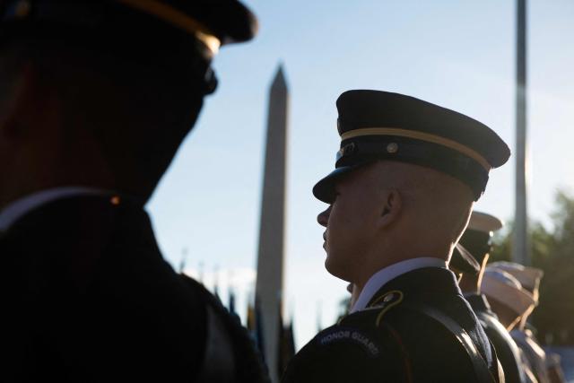 Service members listen to the speakers on the stage during a kick-off celebration for the "Great American State Fair" on the National Mall in Washington, DC, June 24, 2026. The "Great American State Fair" will be held from June 25 to July 10, 2026, to celebrate the 250th anniversary of US independence. (Photo by Matthew Hatcher / AFP)
