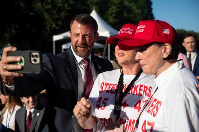 US Secretary of Homeland Security Markwayne Mullin takes a selfie with attendees during a kick-off celebration for the "Great American State Fair" on the National Mall in Washington, DC, June 24, 2026. The "Great American State Fair" will be held from June 25 to July 10, 2026, to celebrate the 250th anniversary of US independence. (Photo by Matthew Hatcher / AFP)