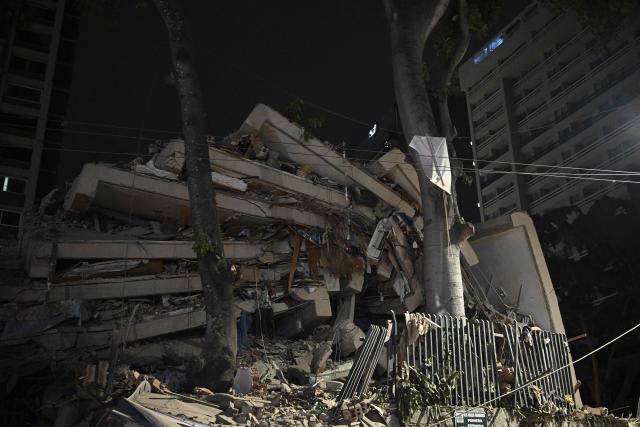 A collapsed building is seen following an earthquake in Caracas on June 24, 2026. Two earthquakes of magnitude 7.2 and 7.5 struck the same area of Venezuela on the evening of June 24, causing buildings to collapse, according to the United States Geological Survey (USGS) and AFP journalists. The quakes drove residents of the capital, Caracas, into the streets. (Photo by Federico PARRA / AFP)