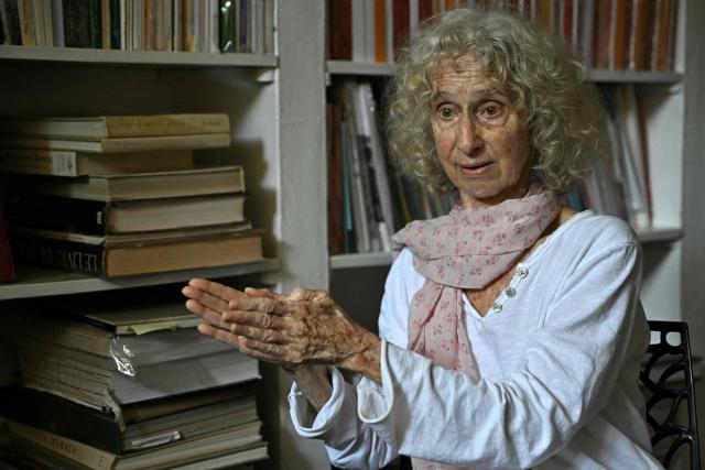 This photograph taken on February 27, 2026 shows Christine Devin, in charge of the Auroville Press, speaking with AFP during an interview in Auroville near Puducherry. For decades Auroville held fast to its lofty ideals as a self-governing haven for yoga enthusiasts and seekers of spiritual freedom of "all creeds and all nationalities". Until India's Hindu nationalist prime minister Narendra Modi turned his attention to the lush paradise its founders created on an once arid plateau Puducherry. Those most at risk are the half of Auroville's 3,300 residents who were born abroad, and who now live in fear of being expelled or denied visas to remain. (Photo by Idrees MOHAMMED / AFP)