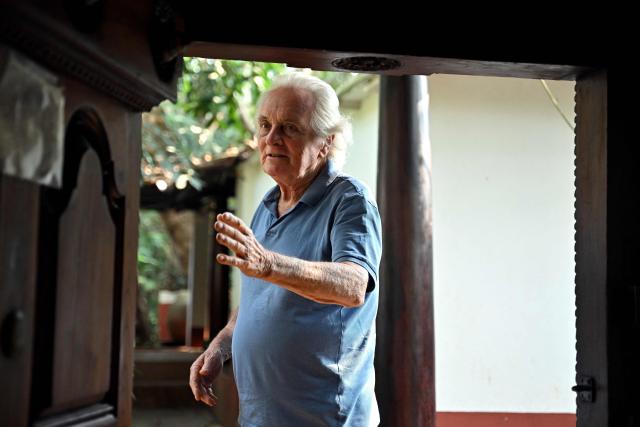 This photograph taken on February 27, 2026 shows Gilles Guigan, a civil engineer, speaking with AFP during an interview in Auroville near Puducherry. For decades Auroville held fast to its lofty ideals as a self-governing haven for yoga enthusiasts and seekers of spiritual freedom of "all creeds and all nationalities". Until India's Hindu nationalist prime minister Narendra Modi turned his attention to the lush paradise its founders created on an once arid plateau Puducherry. Those most at risk are the half of Auroville's 3,300 residents who were born abroad, and who now live in fear of being expelled or denied visas to remain. (Photo by Idrees MOHAMMED / AFP)