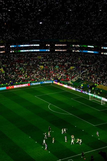 Mexico's players warm up at half-time of the 2026 World Cup Group A football match between the Czech Republic and Mexico at the Mexico City Stadium in Mexico City on June 24, 2026.  (Photo by Rodrigo Oropeza / AFP)