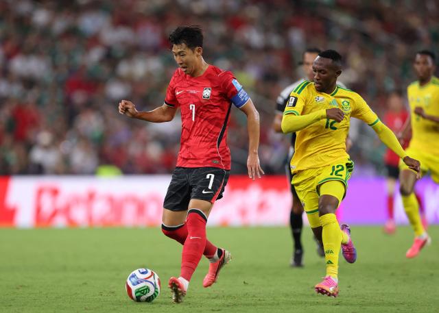 South Korea's forward #07 Son Heung-min controls the ball followed by South Africa's forward #12 Thapelo Maseko during the 2026 World Cup Group A football match between South Africa and South Korea at the Monterrey Stadium in Guadalupe, Mexico, on June 24, 2026.  (Photo by Julio Cesar AGUILAR / AFP)