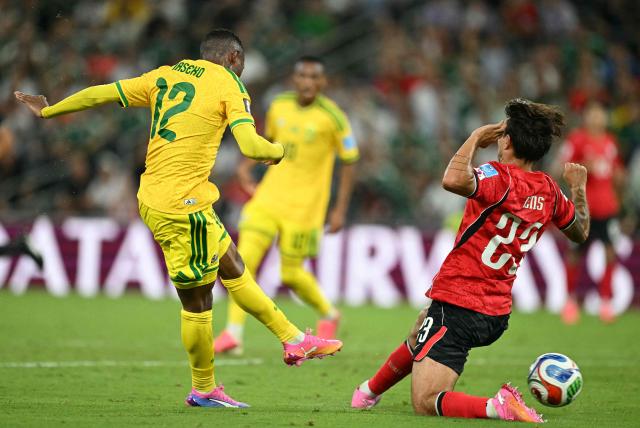 South Africa's forward #12 Thapelo Maseko shoots to score  his team's first goal as he's defended by South Korea's defender #23 Jens Castrop during the 2026 World Cup Group A football match between South Africa and South Korea at the Monterrey Stadium in Guadalupe, Mexico, on June 24, 2026.  (Photo by Yuri CORTEZ / AFP)