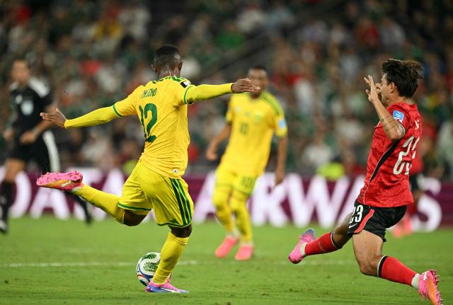 South Africa's forward #12 Thapelo Maseko shoots to score  his team's first goal as he's defended by South Korea's defender #23 Jens Castrop during the 2026 World Cup Group A football match between South Africa and South Korea at the Monterrey Stadium in Guadalupe, Mexico, on June 24, 2026.  (Photo by Yuri CORTEZ / AFP)
