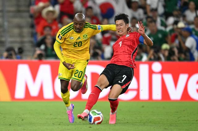South Korea's forward #07 Son Heung-min and South Africa's defender #20 Khuliso Mudau fight for the ball during the 2026 World Cup Group A football match between South Africa and South Korea at the Monterrey Stadium in Guadalupe, Mexico, on June 24, 2026.  (Photo by Yuri CORTEZ / AFP)