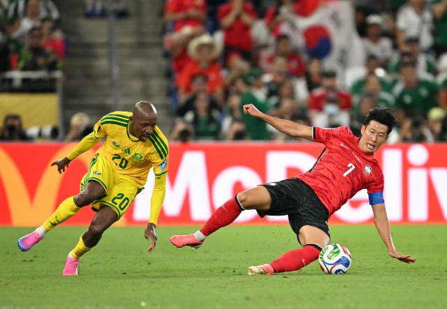 South Korea's forward #07 Son Heung-min and South Africa's defender #20 Khuliso Mudau fight for the ball during the 2026 World Cup Group A football match between South Africa and South Korea at the Monterrey Stadium in Guadalupe, Mexico, on June 24, 2026.  (Photo by Yuri CORTEZ / AFP)