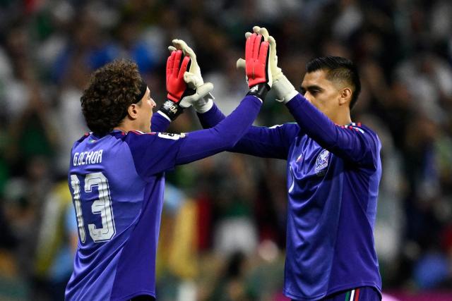 Mexico's goalkeeper #13 Guillermo Ochoa greets teammate goalkeeper #01 Raul Rangel as he is substituted in during the 2026 World Cup Group A football match between the Czech Republic and Mexico at the Mexico City Stadium in Mexico City on June 24, 2026.  (Photo by Alfredo ESTRELLA / AFP)