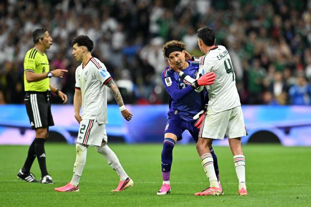 Mexico's goalkeeper #13 Guillermo Ochoa hugs teammate midfielder #04 Edson Alvarez as he is substituted in during the 2026 World Cup Group A football match between the Czech Republic and Mexico at the Mexico City Stadium in Mexico City on June 24, 2026.  (Photo by CARL DE SOUZA / AFP)
