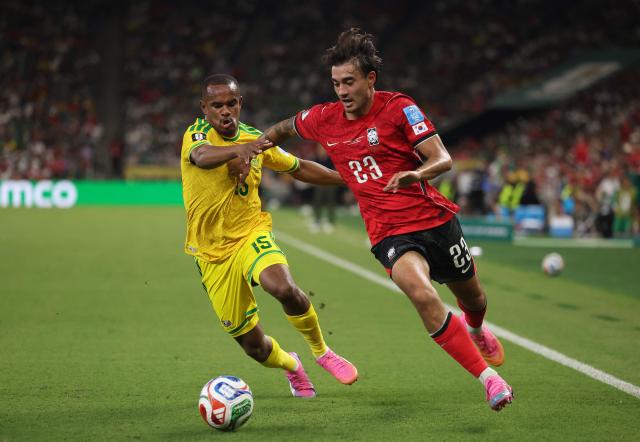 South Korea's defender #23 Jens Castrop and South Africa's forward #15 Iqraam Rayners fight for the ball during the 2026 World Cup Group A football match between South Africa and South Korea at the Monterrey Stadium in Guadalupe, Mexico, on June 24, 2026.  (Photo by Julio Cesar AGUILAR / AFP)