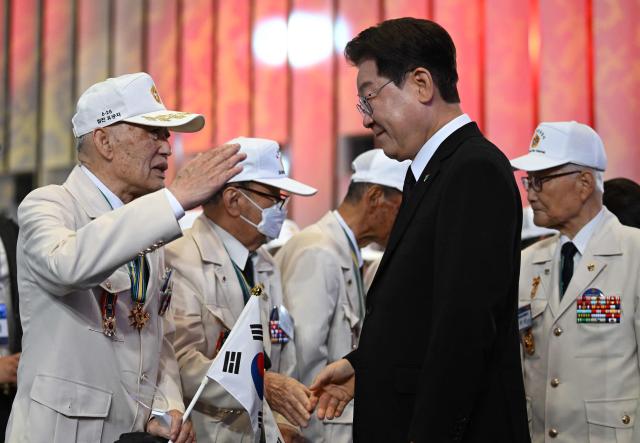 South Korean President Lee Jae Myung greets war veterans during a ceremony marking the 76th anniversary of the outbreak of the Korean War in Suwon on June 25, 2026. (Photo by Jung Yeon-je / AFP)