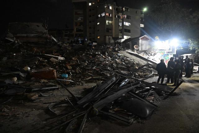 Rescuers and members of the National Guard work at the site of a collapsed building following an earthquake in Caracas on June 24, 2026. Two earthquakes of magnitude 7.2 and 7.5 struck the same area of Venezuela on the evening of June 24, causing buildings to collapse, according to the United States Geological Survey (USGS) and AFP journalists. The quakes drove residents of the capital, Caracas, into the streets. (Photo by Juan BARRETO / AFP)
