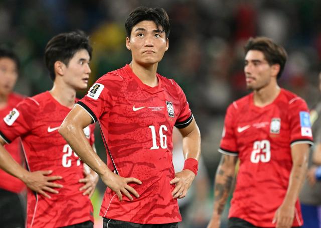 South Korea's midfielder #16 Park Jin-seob and teammates react after they lost the 2026 World Cup Group A football match between South Africa and South Korea at the Monterrey Stadium in Guadalupe, Mexico, on June 24, 2026.  (Photo by Yuri CORTEZ / AFP)