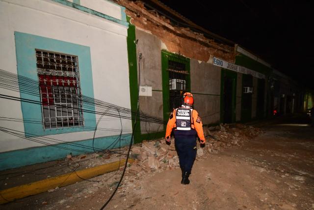 A Carabobo Civil Protection worker inspects the site of a damaged building following an earthquake in Valencia, Venezuela on June 24, 2026. Two earthquakes of magnitude 7.2 and 7.5 struck the same area of Venezuela on the evening of June 24, causing buildings to collapse, according to the United States Geological Survey (USGS) and AFP journalists. The quakes drove residents of the capital, Caracas, into the streets. (Photo by Jacinto OLIVEROS / AFP)