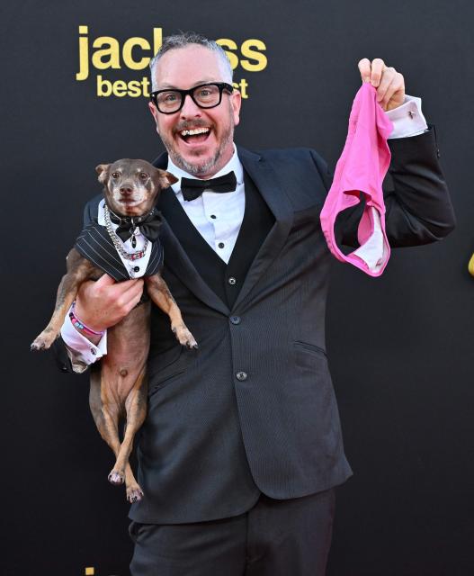 US stunt performer Ehren McGhehey and dog Bugsy attend the Los Angeles premiere of "Jackass: Best and Last" at the Paramount Theatre in Los Angeles on June 23, 2026. (Photo by LISA O'CONNOR / AFP)