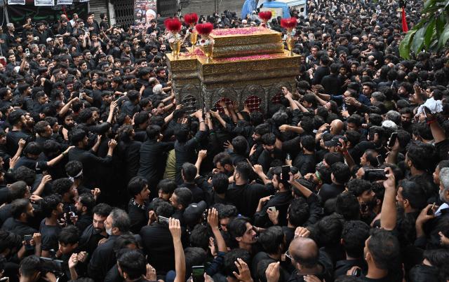 Shiite Muslims participate in a Muharram procession on the ninth day of Ashura in Lahore on June 25, 2026. (Photo by Arif ALI / AFP)
