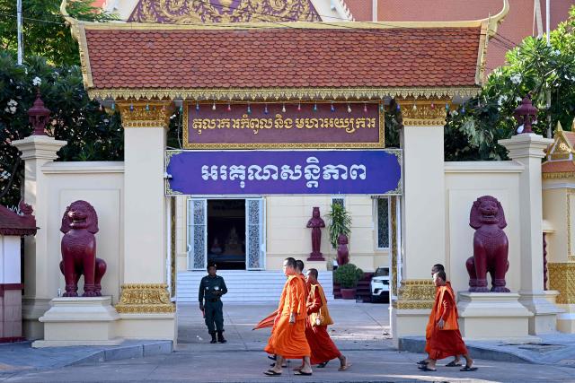 Cambodian Buddhist monks walk in front of the Supreme Court in Phnom Penh on June 25, 2026. Cambodia's Supreme Court on June 25 upheld 14-year prison sentences for two journalists convicted of treason for posting a photo taken in a military-restricted area after a round of border clashes with Thailand, a judge told AFP. (Photo by TANG CHHIN Sothy / AFP)