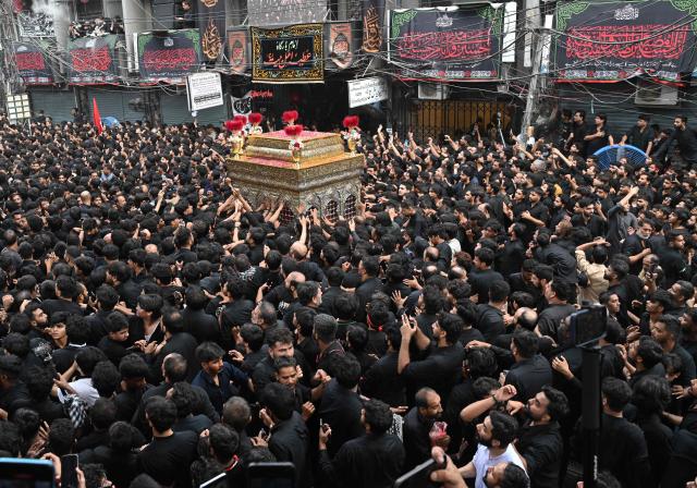 Shiite Muslims participate in a Muharram procession on the ninth day of Ashura in Lahore on June 25, 2026. (Photo by Arif ALI / AFP)