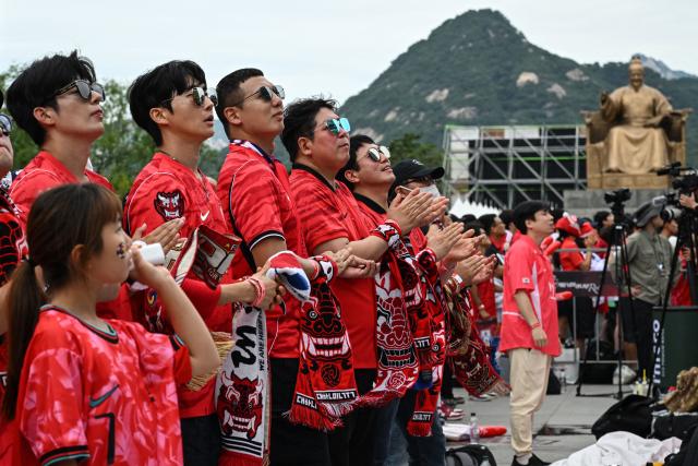 South Korean fans watch the 2026 World Cup football match between South Korea and South Africa on big screens at Gwanghwamun Square in Seoul on June 25, 2026. (Photo by Jade GAO / AFP)