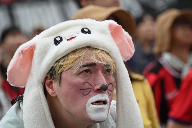 A South Korean fan reacts as he watches the 2026 World Cup football match between South Korea and South Africa on big screens at Gwanghwamun Square in Seoul on June 25, 2026. (Photo by Jade GAO / AFP)