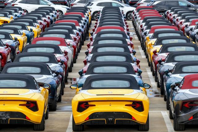 Chinese-made MG Cyberster electric vehicles wait to be loaded onto a ship for export at a car yard in Yantai, China’s eastern Shandong province on June 25, 2026. (Photo by CN-STR / AFP) / China OUT