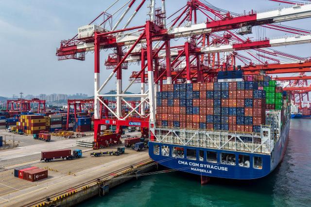 A container ship is berthed at the container terminal in Qingdao, China’s eastern Shandong province on June 25, 2026. (Photo by CN-STR / AFP) / China OUT