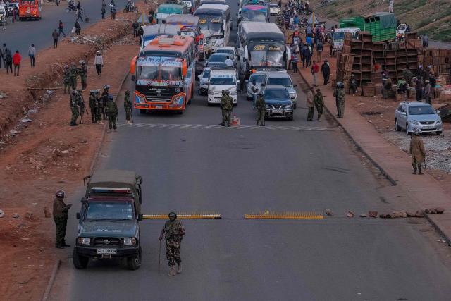 Kenyan police officers man a roadblock in the Central Business District (CBD) in the Kangemi neighbourhood ahead of the planned demonstrations to mark the second anniversary of the deadly June 2024 youth-led anti-Finance Bill protests, which saw demonstrators storm Parliament, in Nairobi on June 25, 2026. Thousands of Kenyans protested in June 2024 against economic hardship and corruption, eventually storming parliament to force the cancellation of new taxes. (Photo by Kabir DHANJI / AFP)