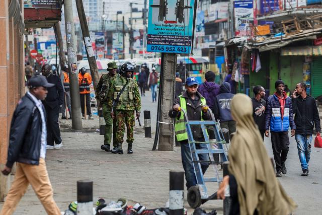 Police patrol along a commercial street in the Central Business District (CBD) ahead of the planned demonstrations to mark the second anniversary of the deadly June 2024 youth-led anti-Finance Bill protests, which saw demonstrators storm Parliament, in Nairobi on June 25, 2026. Thousands of Kenyans protested in June 2024 against economic hardship and corruption, eventually storming parliament to force the cancellation of new taxes. (Photo by Tony KARUMBA / AFP)