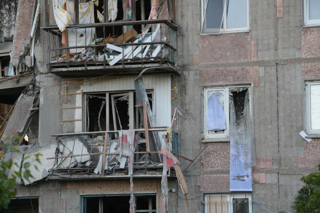 A view taken on June 24, 2026 shows a heavily damaged multi-storey apartment building following a recent attack, which local Russian-installed officials called a Ukrainian drone strike, in the town of Gorlivka in the Donetsk region, Russian-controlled Ukraine, amid the ongoing Russian-Ukrainian conflict. (Photo by AFP)