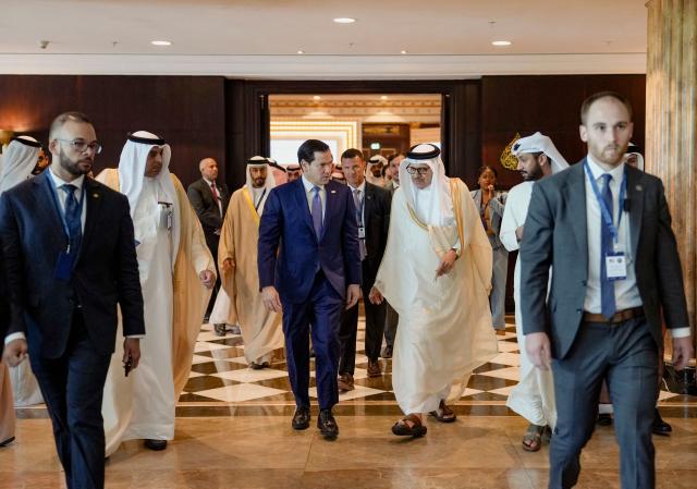 US Secretary of State Marco Rubio (C-L) walks along side Bahrain's Foreign Minister and Chairman of the GCC Ministerial Council session Abdullatif bin Rashid al-Zayani following a meeting with foreign ministers of the Gulf Cooperation Council Member States (GCC), in Manama on June 25, 2026. Top US diplomat Marco Rubio was in Bahrain on June 25, after promising Gulf allies that Washington would protect their interests as it seeks to hammer out a final settlement to end the war with Iran. Rubio is on a regional tour to reassure the Gulf states, which were targeted by Tehran's missiles and drones during the conflict and saw their crucial oil and gas shipments effectively cut off by an Iranian blockade of the Strait of Hormuz. (Photo by Eric Lee / POOL / AFP)