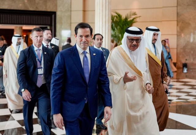 US Secretary of State Marco Rubio (L) walks along side Bahrain's Foreign Minister and Chairman of the GCC Ministerial Council session Abdullatif bin Rashid al-Zayani following a meeting with foreign ministers of the Gulf Cooperation Council Member States (GCC), in Manama on June 25, 2026. Top US diplomat Marco Rubio was in Bahrain on June 25, after promising Gulf allies that Washington would protect their interests as it seeks to hammer out a final settlement to end the war with Iran. Rubio is on a regional tour to reassure the Gulf states, which were targeted by Tehran's missiles and drones during the conflict and saw their crucial oil and gas shipments effectively cut off by an Iranian blockade of the Strait of Hormuz. (Photo by Eric Lee / POOL / AFP)