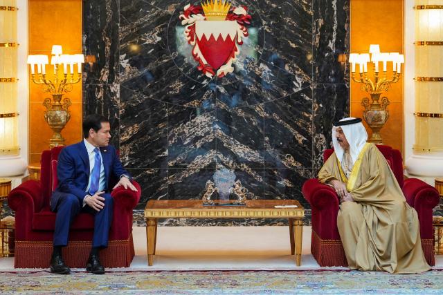 US Secretary of State Marco Rubio (L) meets with Bahrain's King Hamad bin Isa al-Khalifa during his visit to the Middle East to discuss the interim deal between the US and Iran with Arab Gulf allies, and to attend a meeting by the Gulf Cooperation Council Member States (GCC), at Al-Sakhir Palace, near Zallaq on June 25, 2026. Top US diplomat Marco Rubio was in Bahrain on June 25, after promising Gulf allies that Washington would protect their interests as it seeks to hammer out a final settlement to end the war with Iran. Rubio is on a regional tour to reassure the Gulf states, which were targeted by Tehran's missiles and drones during the conflict and saw their crucial oil and gas shipments effectively cut off by an Iranian blockade of the Strait of Hormuz. (Photo by Eric Lee / POOL / AFP)