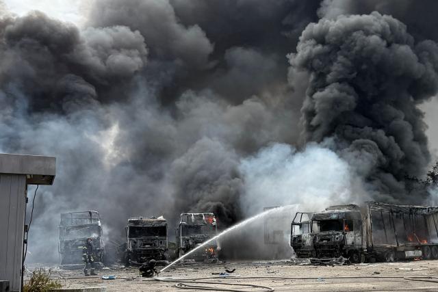 Ukrainian rescuers work to extinguish a fire at the site of an air attack in Zaporizhzhia on June 25, 2026, amid the Russian invasion of Ukraine.  (Photo by Darya NAZAROVA / AFP)
