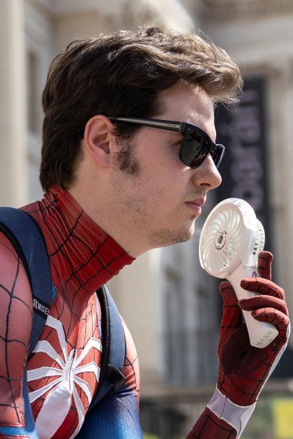 A Spider-man fan in costume tries to cool off in the heat while waiting for a promotional event for the upcoming premiere of the film "Spider-Man: Brand New Day", in central London on June 25, 2026. (Photo by Brook Mitchell / AFP)