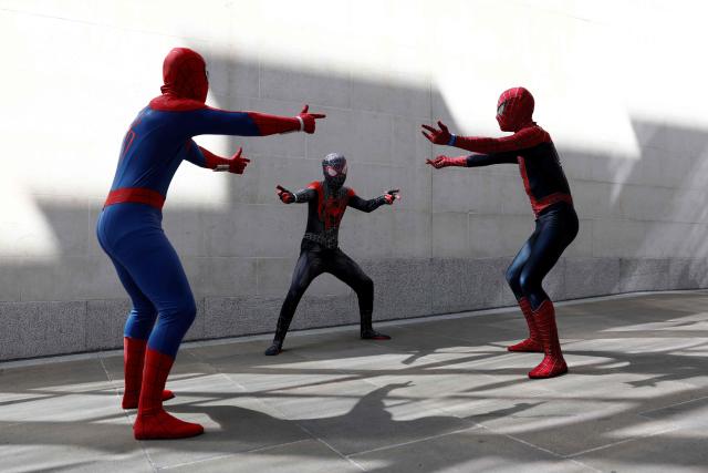 Spider-man fans in costume pose while waiting for a promotional event for the upcoming premiere of the film "Spider-Man: Brand New Day", in central London on June 25, 2026. The red carpet photo call event was scaled back due to the extreme heat parts in England this week. (Photo by Brook Mitchell / AFP)