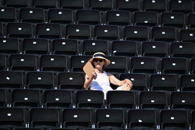 A woman wears a hat and sunglasses to protect against the sun at the WTA 500 Bad Homburg Open tennis tournament in Bad Homburg, western Germany on June 25, 2026. (Photo by Kirill KUDRYAVTSEV / AFP)