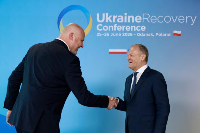 Polish Prime Minister Donald Tusk (R) welcomes Latvia's Prime Minister Andris Kulbergs as he arrives to attend the Ukraine Recovery Conference (URC 2026) in Gdansk, Poland, on June 25, 2026. The Ukraine Recovery Conference (URC 2026), co-hosted by Poland and Ukraine, takes place in Gdansk on June 25–26, 2026, aiming to strengthen support for Ukraine’s reconstruction and boost investment, with a focus on energy, critical infrastructure, and logistics sectors. (Photo by Wojtek RADWANSKI / AFP)