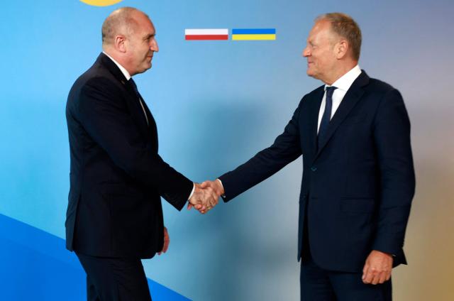 Polish Prime Minister Donald Tusk (R) welcomes Bulgaria's Prime Minister Rumen Radev as he arrives to attend the Ukraine Recovery Conference (URC 2026) in Gdansk, Poland, on June 25, 2026. The Ukraine Recovery Conference (URC 2026), co-hosted by Poland and Ukraine, takes place in Gdansk on June 25–26, 2026, aiming to strengthen support for Ukraine’s reconstruction and boost investment, with a focus on energy, critical infrastructure, and logistics sectors. (Photo by Wojtek RADWANSKI / AFP)