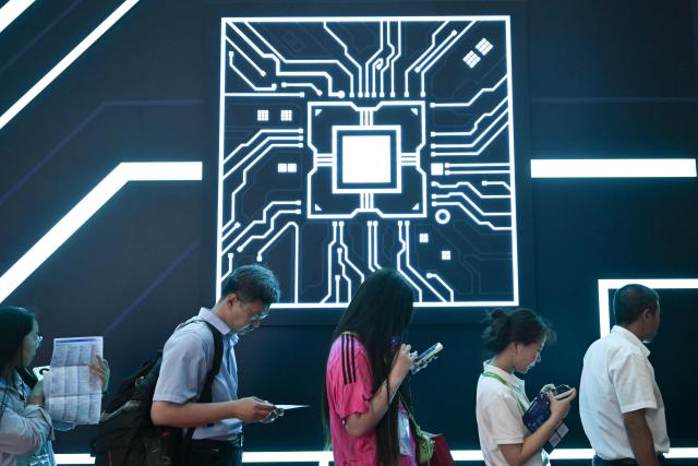 Visitors line up to enter the SK Group booth during the China International Supply Chain Expo (CISCE) in Beijing on June 25, 2026. (Photo by Pedro PARDO / AFP)