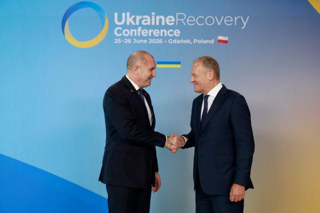 Polish Prime Minister Donald Tusk (R) welcomes Bulgaria's Prime Minister Rumen Radev as he arrives to attend the Ukraine Recovery Conference (URC 2026) in Gdansk, Poland, on June 25, 2026. The Ukraine Recovery Conference (URC 2026), co-hosted by Poland and Ukraine, takes place in Gdansk on June 25–26, 2026, aiming to strengthen support for Ukraine’s reconstruction and boost investment, with a focus on energy, critical infrastructure, and logistics sectors. (Photo by Wojtek RADWANSKI / AFP)