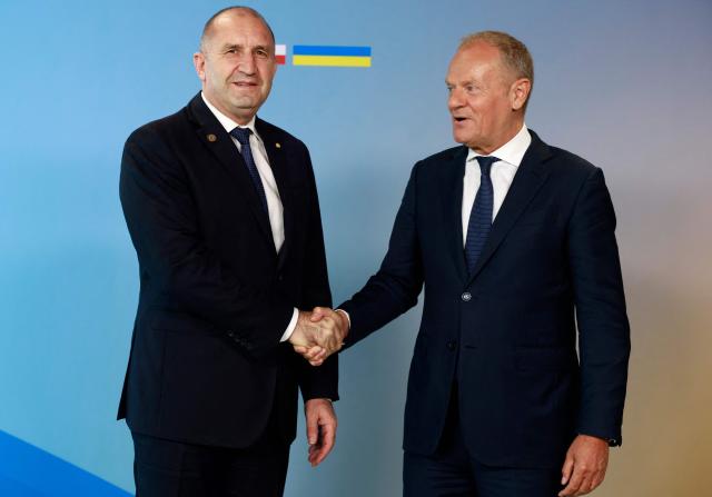 Polish Prime Minister Donald Tusk (R) welcomes Bulgaria's Prime Minister Rumen Radev as he arrives to attend the Ukraine Recovery Conference (URC 2026) in Gdansk, Poland, on June 25, 2026. The Ukraine Recovery Conference (URC 2026), co-hosted by Poland and Ukraine, takes place in Gdansk on June 25–26, 2026, aiming to strengthen support for Ukraine’s reconstruction and boost investment, with a focus on energy, critical infrastructure, and logistics sectors. (Photo by Wojtek RADWANSKI / AFP)