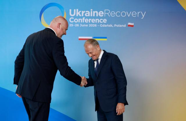 Polish Prime Minister Donald Tusk (R) welcomes Latvia's Prime Minister Andris Kulbergs as he arrives to attend the Ukraine Recovery Conference (URC 2026) in Gdansk, Poland, on June 25, 2026. The Ukraine Recovery Conference (URC 2026), co-hosted by Poland and Ukraine, takes place in Gdansk on June 25–26, 2026, aiming to strengthen support for Ukraine’s reconstruction and boost investment, with a focus on energy, critical infrastructure, and logistics sectors. (Photo by Wojtek RADWANSKI / AFP)